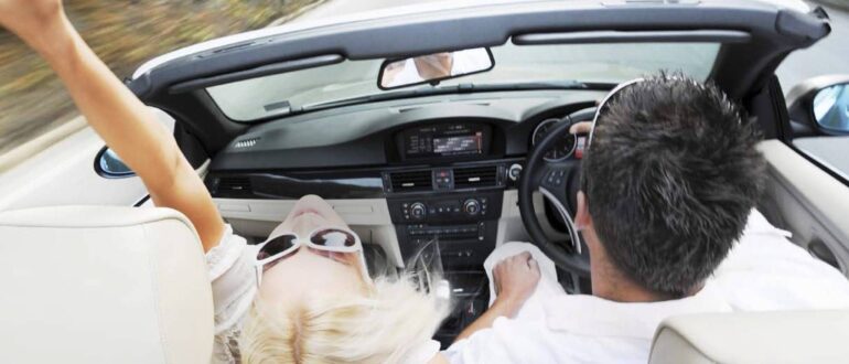 Man and woman in a convertible car