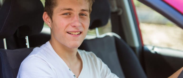 Young man sitting in first car