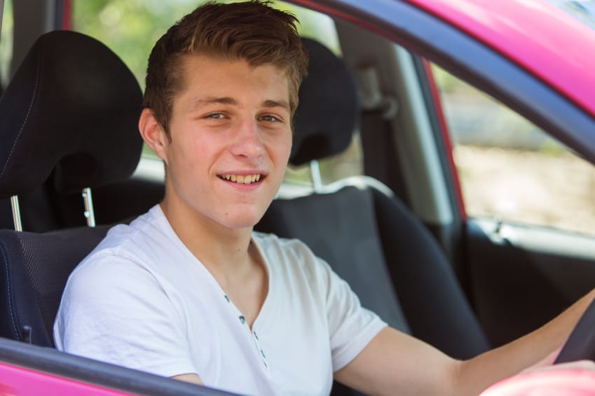 Young man sitting in first car