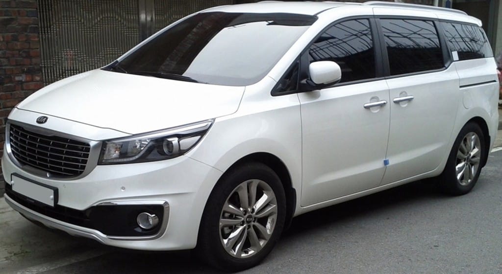 White Kia Carnival side view