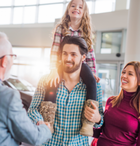 Father and mother with daughter with car broker buying service.