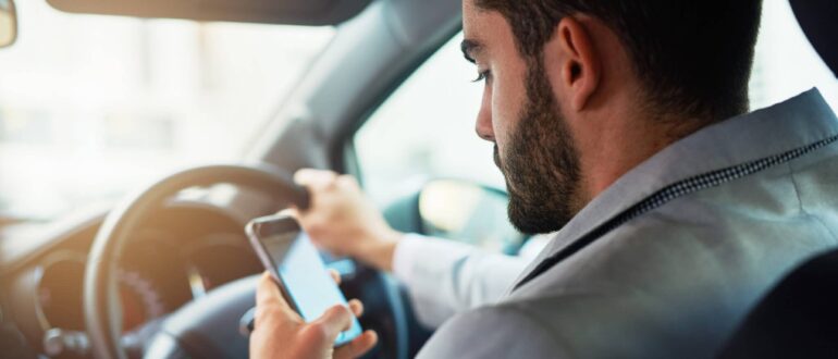 A person in a car using a phone