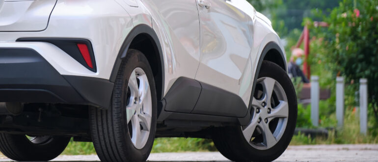 close up of a car parked on city street side.