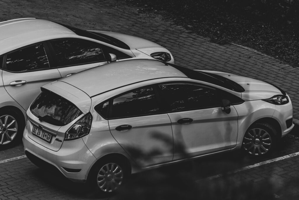 aerial view of two white ford hatchbacks parked in a car park